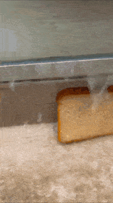 a slice of bread is being pulled out of a refrigerator door