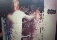 a person standing in front of a sign that says " danger "