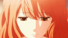 a close up of a girl with long orange hair