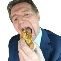 a man in a blue suit is eating a sandwich with his mouth open