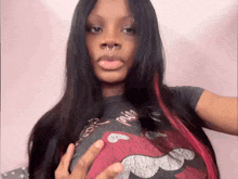 a woman wearing a rolling stones t-shirt shows off her breast