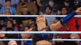 a woman in a wrestling ring with her arms outstretched and the word win on the bottom