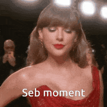 a woman in a red dress with seb moment written on her chest .