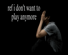 a man sits in a dark room with the words " ref i don t want to play anymore " behind him