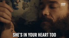 a man with a beard is touching a child 's head and saying she 's in your heart too