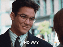 a man wearing glasses and a suit says " no way " in front of him