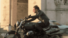a man is riding a motorcycle that says tom cruise mi-6