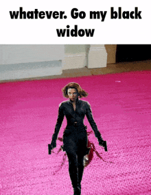 a woman in a black suit is walking on a pink carpet with a caption that says " whatever go my black widow "