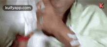 a close up of a person laying on a bed with a bottle of water .