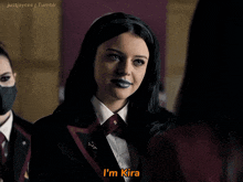 a girl with black lipstick is talking to another girl and says i 'm kira