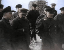 a group of men in military uniforms are walking