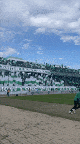 a soccer stadium with a banner that says " how long will i stay "