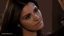 a close up of a woman 's face with her eyes closed .