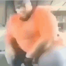 Black Guy Orange Shirt GIF - Black Guy Orange Shirt Invisible Chair GIFs