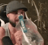a man in a hat is drinking from a bottle that says ' ice trip ' on it