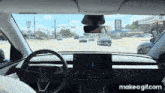 a tesla model 3 is driving down the road