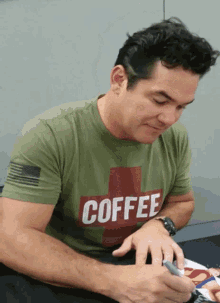 a man in a green shirt that says coffee on it