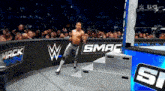 a man in a wrestling ring with the word mack on the wall