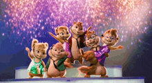 a group of chipmunks are standing on a stage