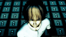 a girl in a white shirt stands in front of a wall of numbered lockers