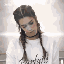 a woman wearing a white sweatshirt that says parfaite