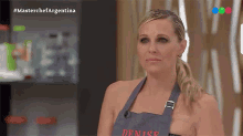 a woman wearing an apron with denise written on it
