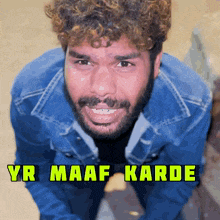 a man with curly hair and a beard is wearing a blue jacket and smiling with the words yr maaf karde written above him