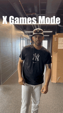 a man standing in a hallway with the words x games mode behind him