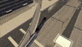 an aerial view of a train traveling down train tracks