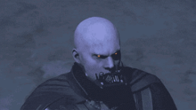 a bald man wearing a black cape and a mask