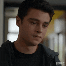 a close up of a man 's face with a netflix logo on the bottom right