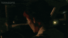 a man in a car with the word terasgifs on the bottom right