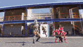 a man in a robot costume is standing in front of a building with the letter cc on it