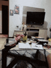 a living room with a pineapple on the coffee table and a flat screen tv