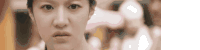 a close up of a woman 's face with a serious expression on her face .