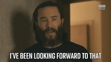 a man with a beard is looking forward to something