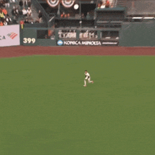 a baseball field with a konica minolta sign in the outfield