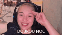 a woman wearing headphones with the words dobrou noc written on the bottom