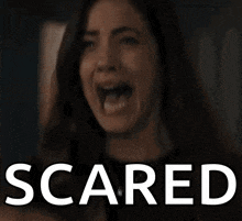 a woman with her mouth wide open and the word scared written below her