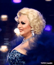 a woman with blonde hair is wearing a blue dress and a necklace ..