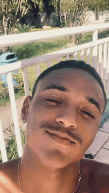 a shirtless man with a mustache is making a funny face
