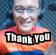 a man wearing glasses and headphones is smiling with the words thank you above him