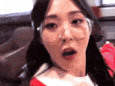 a close up of a woman wearing glasses making a funny face .