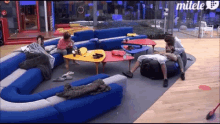 a group of people are sitting in a living room with mitele written on the bottom