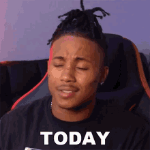 a man with dreadlocks is wearing a black shirt with today written on it