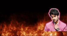 a man in a pink suit and tie is standing in front of flames