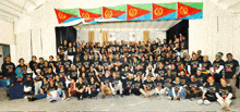 a large group of people are posing for a picture and one of their shirts says " ethiopia "