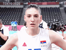 a woman wearing a jersey that says tokyo 2020