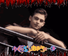 a picture of a man leaning on a railing with the letters sjbm behind him
