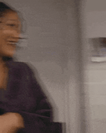 a blurry picture of a woman holding a cup of coffee in her hand .